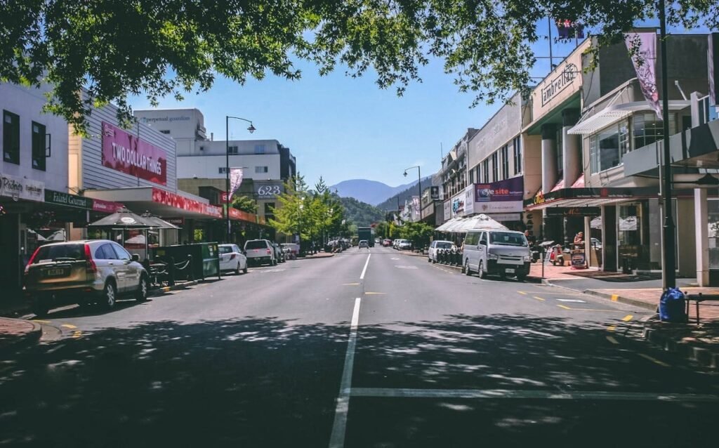 Travel to New Zealand - roadway with parked cars